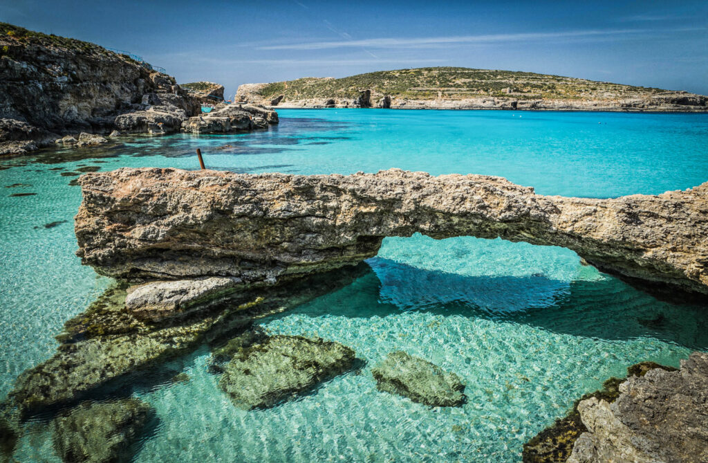 Stunning view of the Blue Lagoon in Malta, showcasing crystal-clear turquoise waters and rugged coastline, perfect for a Blue Lagoon Malta Boat Trip