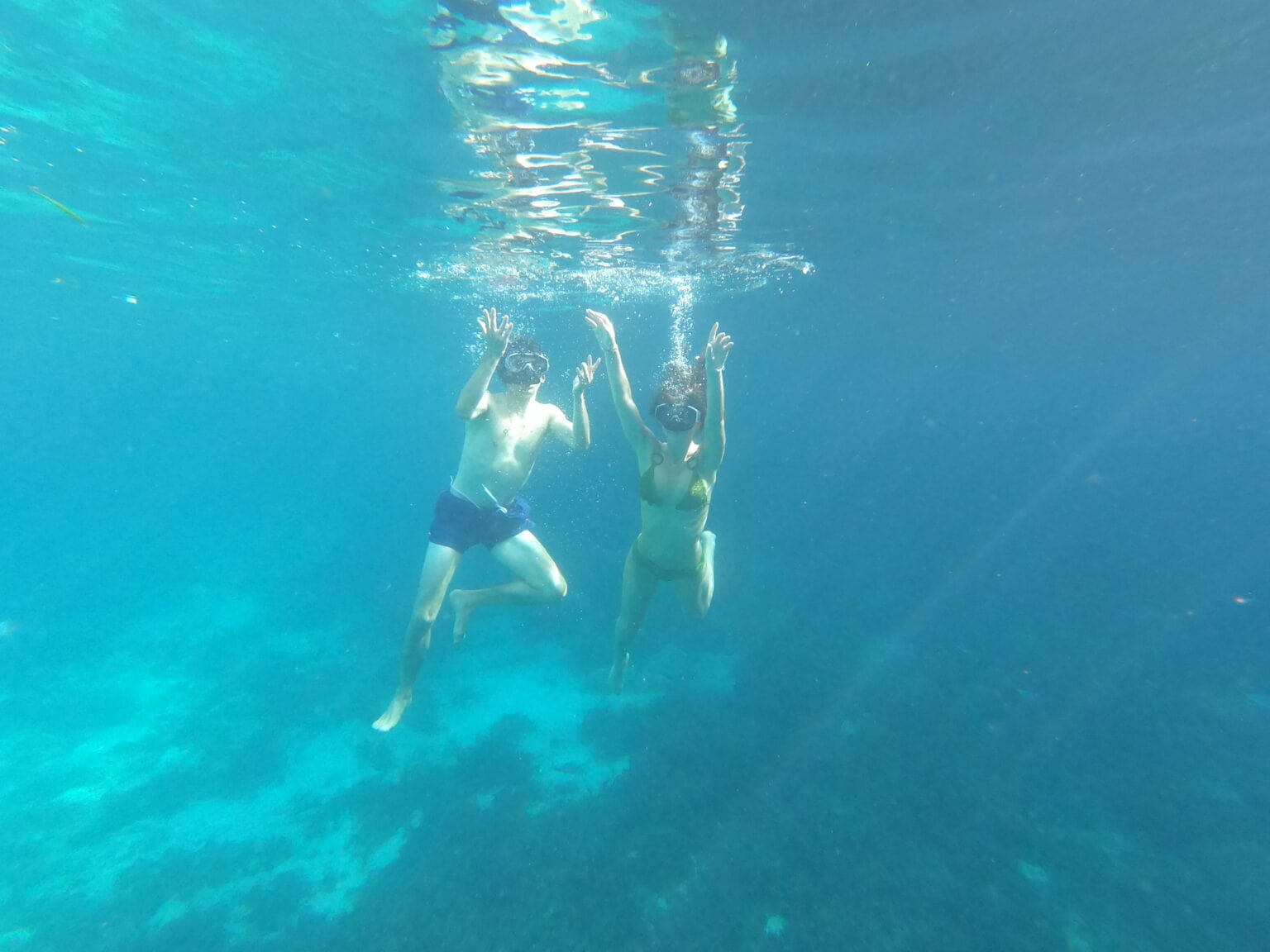 A tourist enjoying snorkeling in the clear waters of Kantra, one of the best places to snorkel in Malta. Discover vibrant marine life and underwater beauty with easy access to this pristine location.