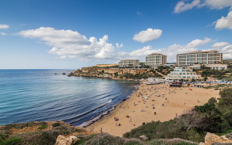 Aerial view of Golden Bay Malta with tourist sunbathing