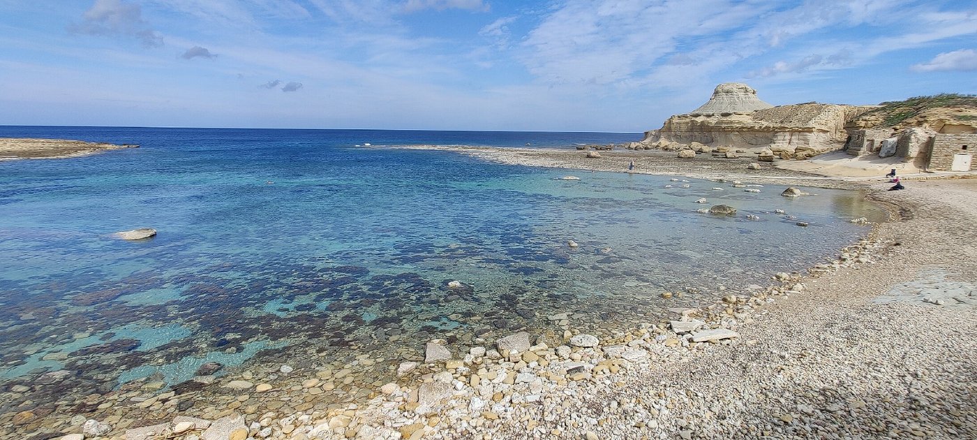 Crystal-clear waters and rocky shoreline at Xwejni Bay in Gozo, one of the best places to snorkel in Malta. Discover vibrant marine life and unique underwater rock formations in this peaceful bay, perfect for snorkelling and swimming adventures.