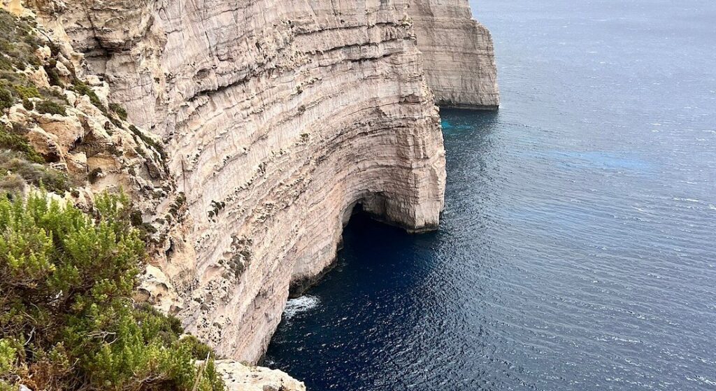 Scenic view of Ta’ Cenc Cliffs Beach in Gozo, Malta, showcasing towering limestone cliffs, rugged coastline, and the deep blue Mediterranean Sea