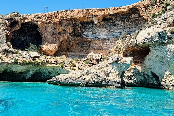 Crystal Lagoon sea caves with turquoise waters and dramatic rock formations, a stunning setting for sea cave tours.