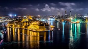 Panoramic view of Valletta and the Three Cities across the Grand Harbour in Malta, showcasing historic fortifications and waterfront architecture