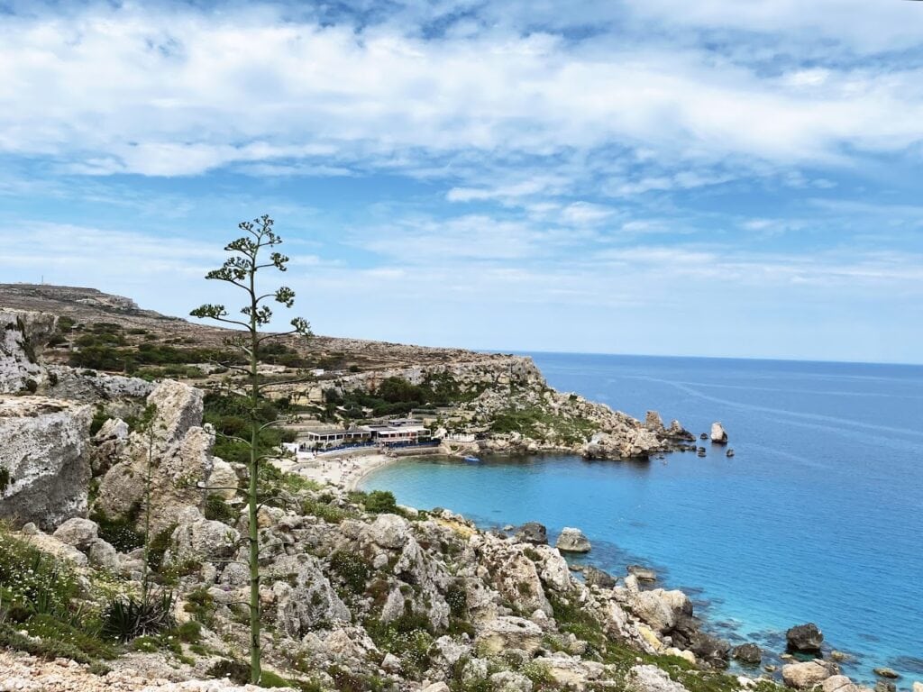 Paradise Bay in Malta featuring turquoise waters and a sandy shoreline, ideal for underwater exploration. Known as one of the best places to snorkel in Malta, this picturesque bay offers clear visibility and vibrant marine life—perfect for snorkelling enthusiasts and beach lovers alike.