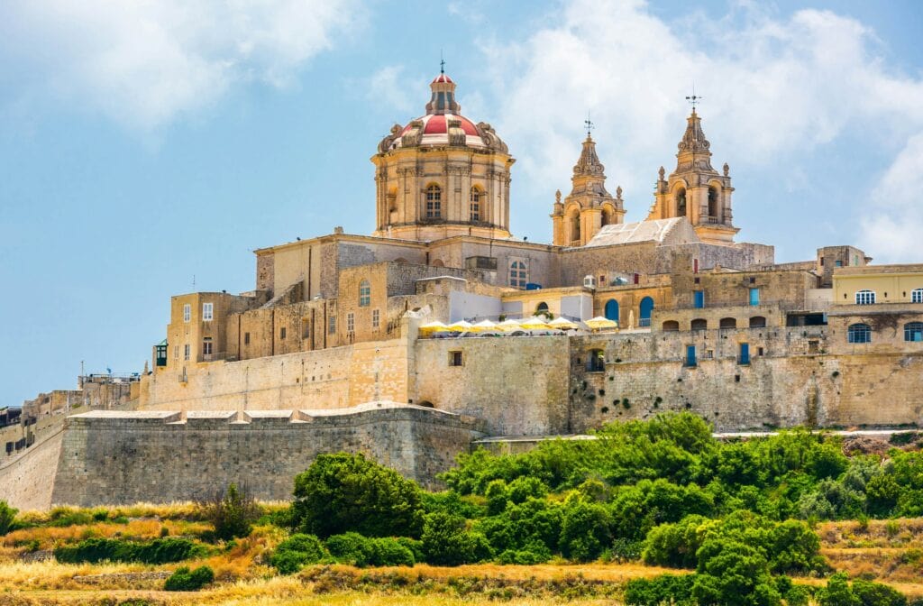 Stunning view of Mdina, Malta’s ancient walled city, known as the ‘Silent City.’ Wander through its narrow streets, admire historic architecture, and enjoy breathtaking panoramic views. A must-visit for history lovers and those exploring the rich heritage of Malta.