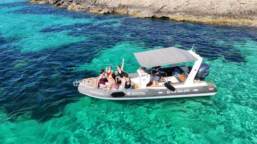 GOZOblu hosting guests on a private boat tour Malta, enjoying the clear blue waters and scenic coastline from the comfort of the boat.