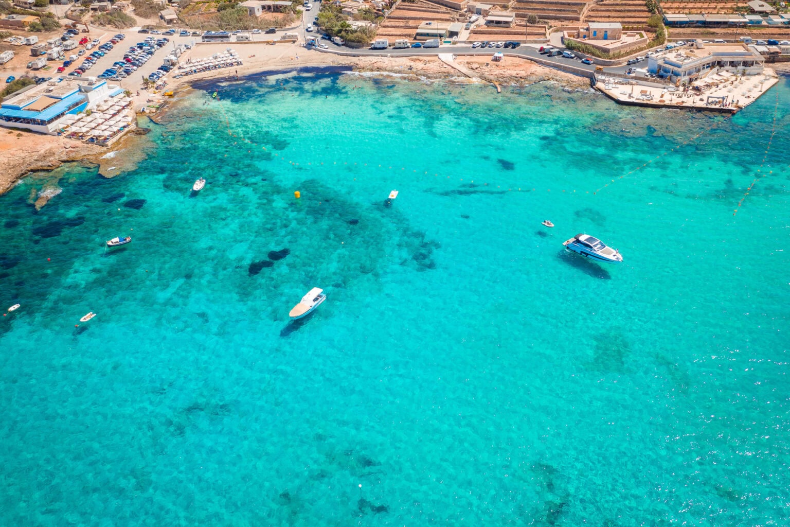Scenic view of the crystal-clear turquoise waters and sandy shoreline at Little Armier Bay Malta