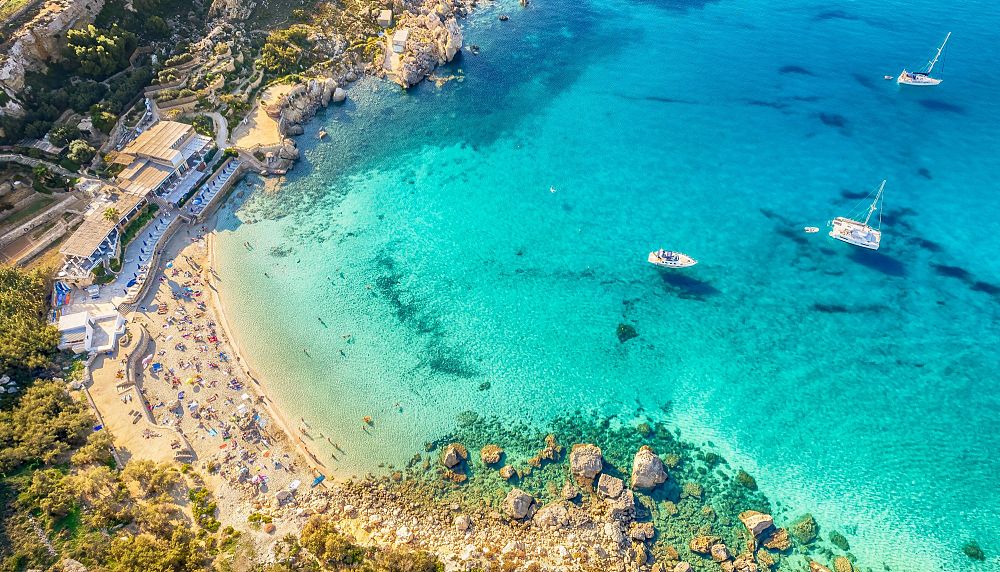 Paradise Bay Beach with crystal-clear turquoise waters, white sand shoreline