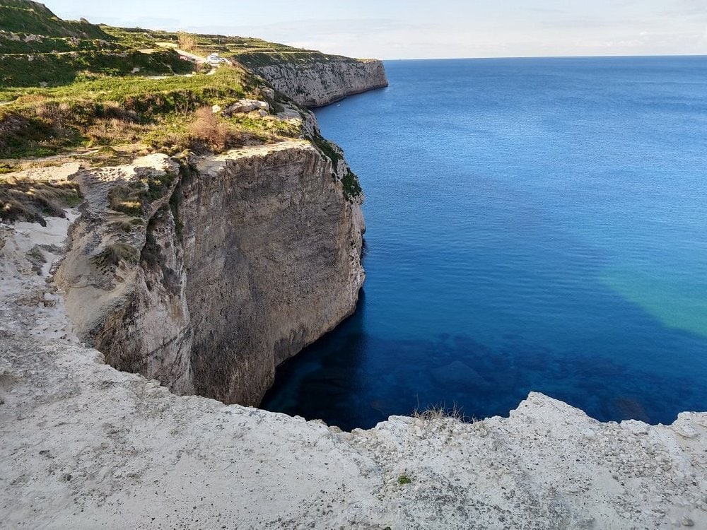 Scenic view of Fomm ir-Rih Bay Malta with clear blue waters, rugged cliffs, and unspoiled natural beauty