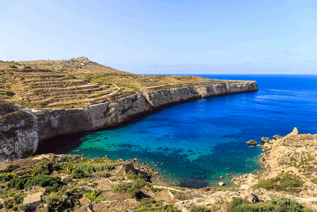 Scenic coastal view of Fomm ir-Rih Bay Malta with turquoise waters, rugged cliffs, and untouched natural landscape.