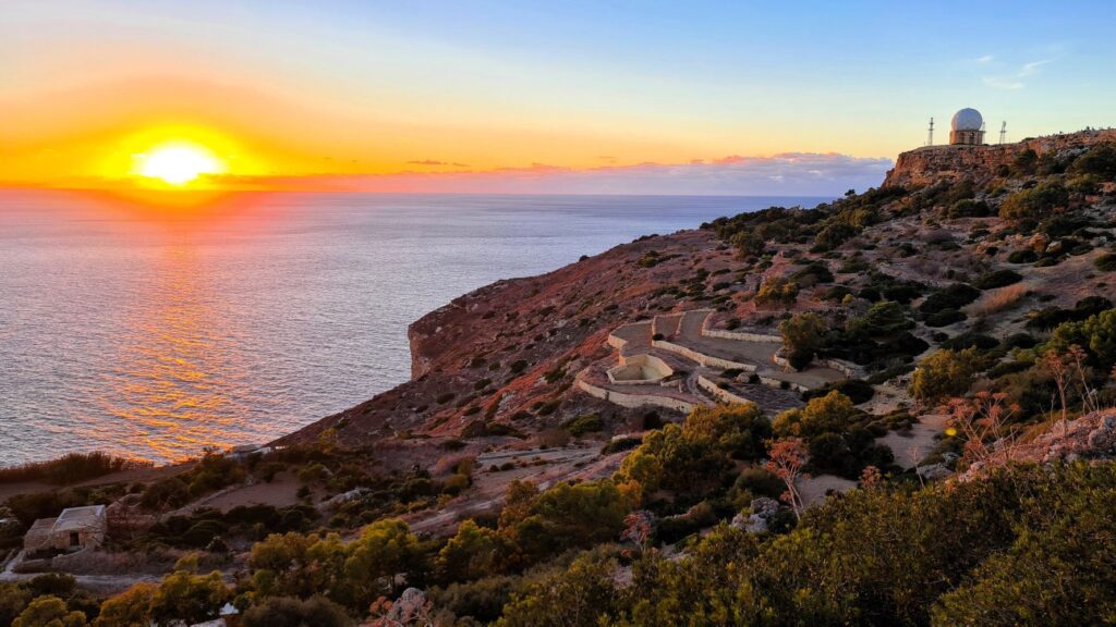 Breathtaking sunset view over Dingli Cliffs Malta with golden skies and panoramic sea horizon