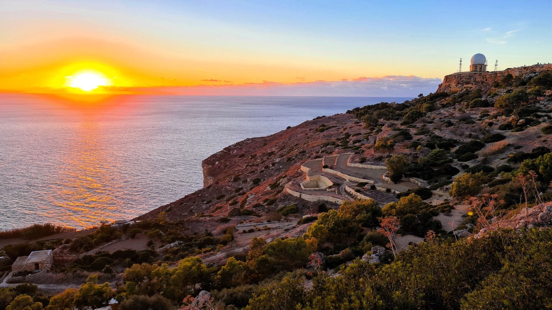 Breathtaking sunset view over Dingli Cliffs Malta with golden skies and panoramic sea horizon