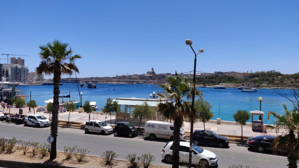 Scenic view of Sliema Beachfront with clear blue waters, a popular spot among beaches near Valletta in Malta