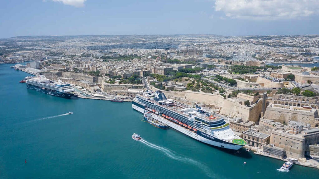 A panoramic view of Valletta’s historic waterfront at the Malta cruise ship port, with cruise liners docked beside the city’s sandstone buildings and fortifications.