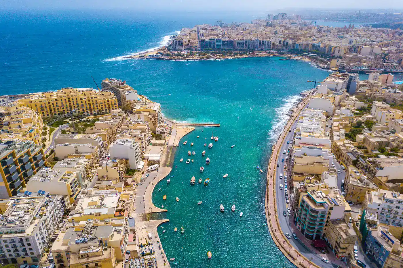 Harbor view of Sliema with boats along the waterfront, highlighting popular Malta Boat Trips from Sliema.