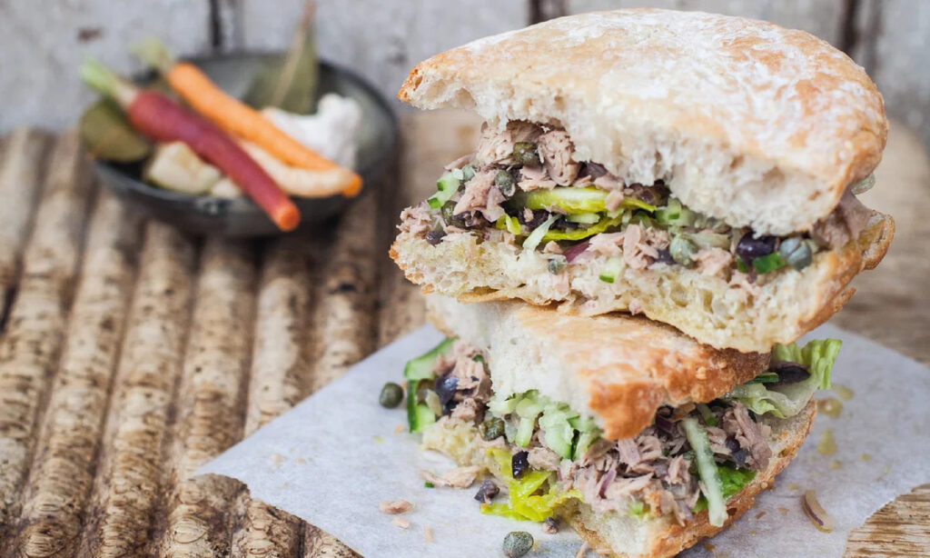 Authentic Maltese ftira sandwich enjoyed during a boat tour in Malta