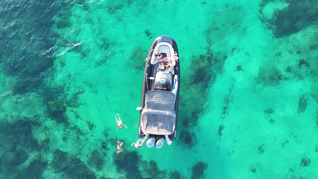 A private boat cruising through the crystal-clear waters of Comino during one of GOZOblu's Full-Day Malta Boat Trips.