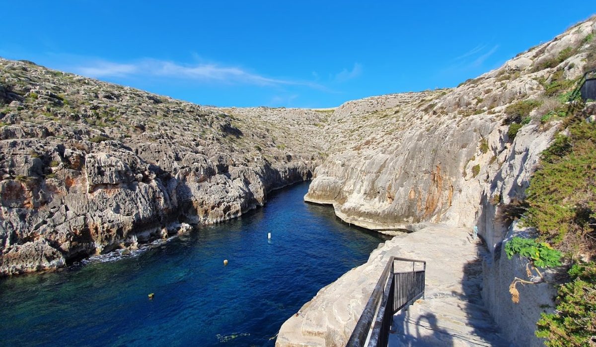 The stunning Blue Grotto in Malta, with its natural rock formations and shimmering turquoise sea.