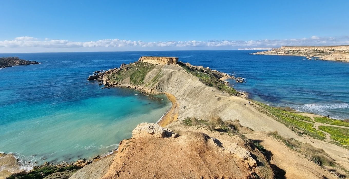 Il-Qarraba Viewpoint Scenic view from Il-Qarraba Viewpoint overlooking Ġħajn Tuffieħa Bay, Malta, with cliffs, turquoise waters, and untouched natural landscapes.