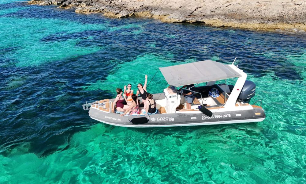 GOZOblu hosting guests on a private boat tour Malta, enjoying the clear blue waters and scenic coastline from the comfort of the boat.