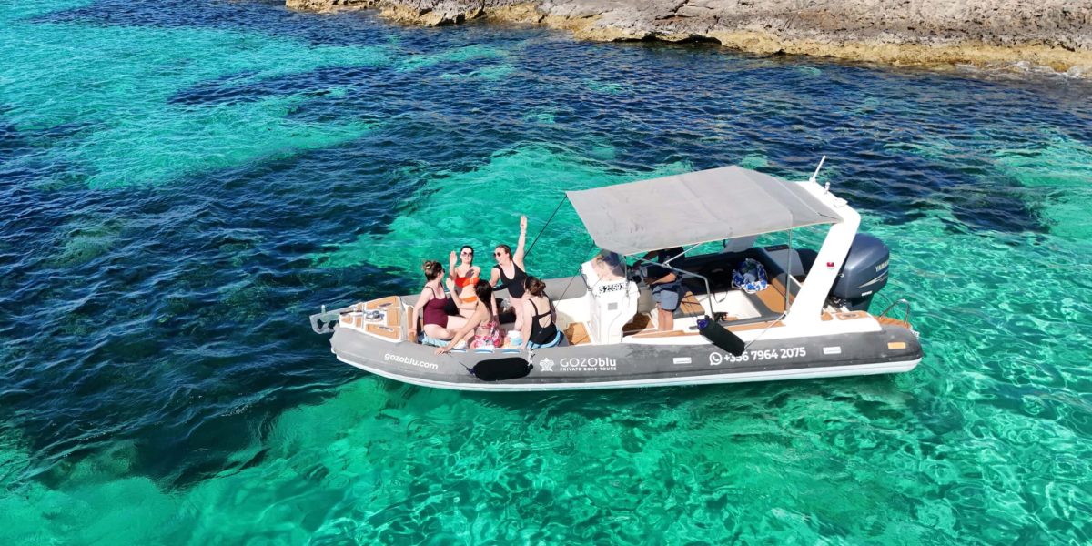 GOZOblu hosting guests on a private boat tour Malta, enjoying the clear blue waters and scenic coastline from the comfort of the boat.