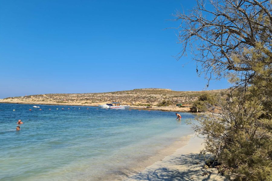 Santa Maria Bay, Malta Scenic view of Santa Maria Bay, Malta, with clear turquoise waters and a tranquil sandy beach.