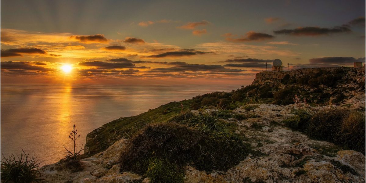 Sunset at Dingli Cliffs in Malta with golden light over the Mediterranean Sea and dramatic coastal views
