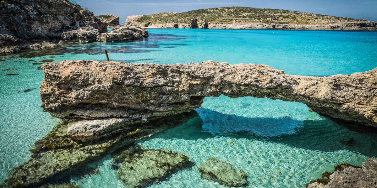 Stunning view of the Blue Lagoon in Malta, showcasing crystal-clear turquoise waters and rugged coastline, perfect for a Blue Lagoon Malta Boat Trip