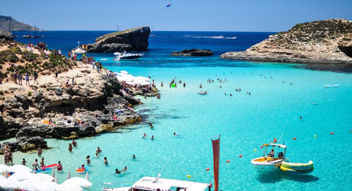 People swimming in the crystal-clear waters of the Blue Lagoon Malta