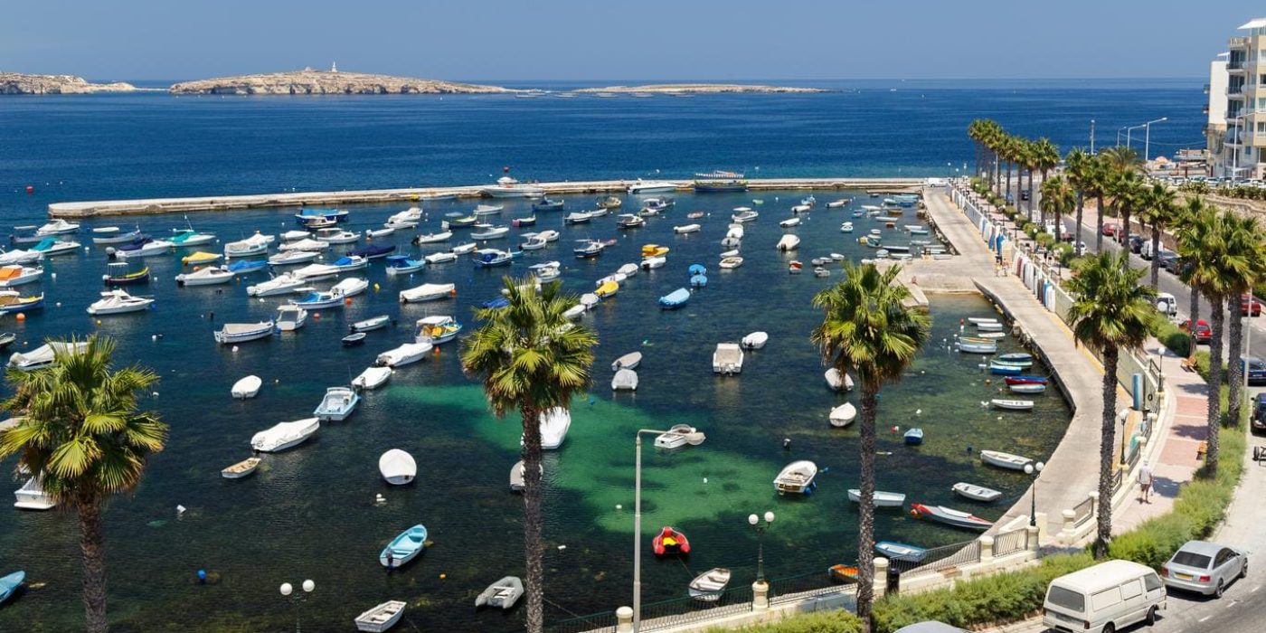 Beautiful coastal view of St. Paul’s Bay, Malta, with crystal-clear waters and picturesque boats. Explore the top things to do in st paul's bay from swimming and snorkelling to discovering nearby islands on a private boat tour.