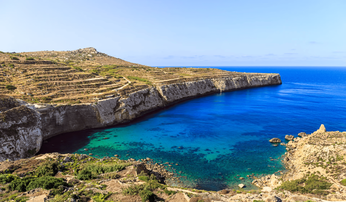 Scenic coastal view of Fomm ir-Rih Bay Malta with turquoise waters, rugged cliffs, and untouched natural landscape.